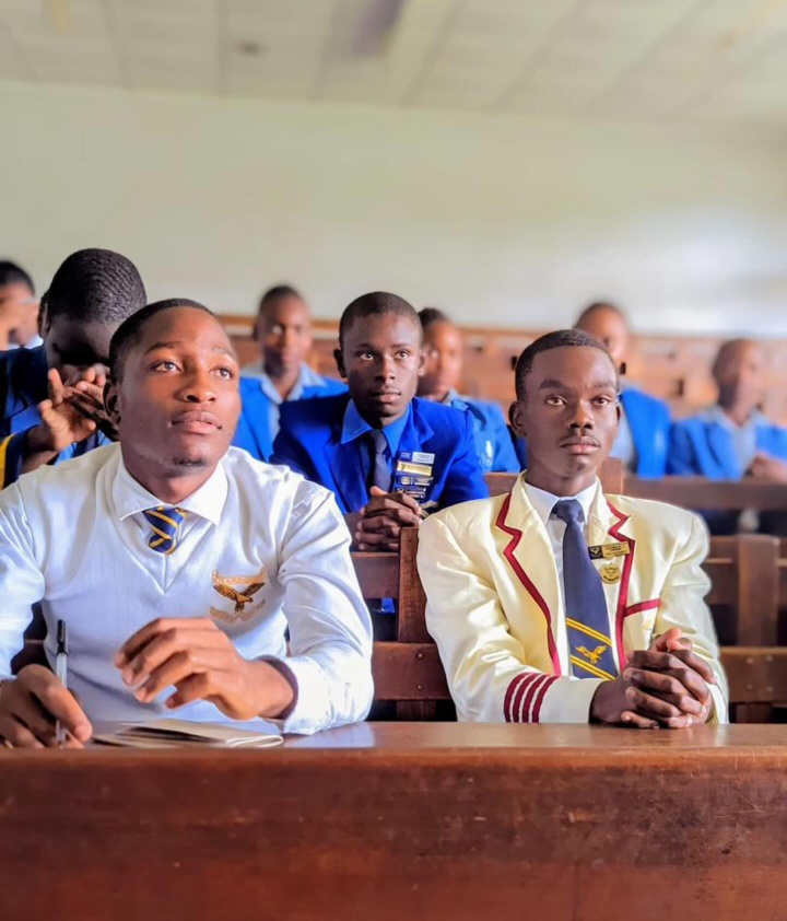 Students seated at classroom desks wearing school uniforms