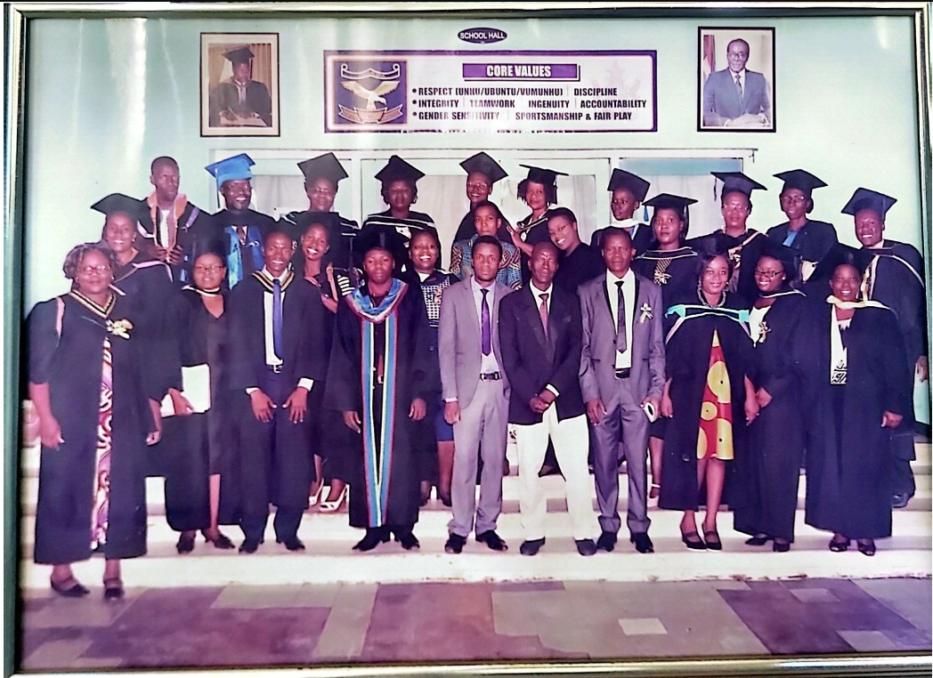 Graduates and staff in academic gowns gathered in the school hall